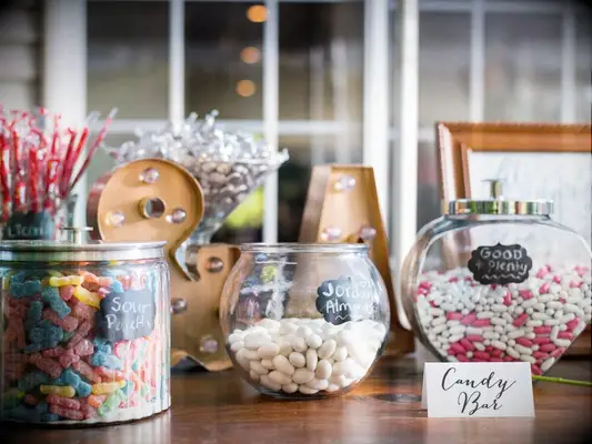Colorful candy bar, that includes Jordan almonds, at a wedding reception.