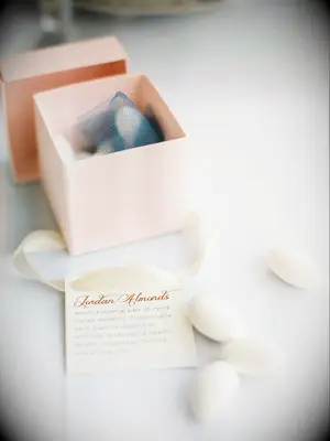 A box of Jordan almonds wedding favors with a small note. 