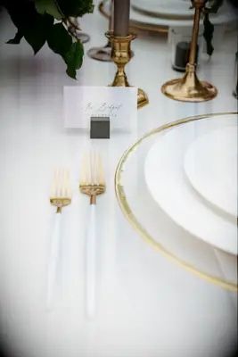 Foil accented and neutral-toned wedding place settings.