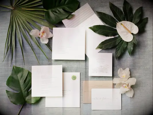 An elegant neutral-toned wedding invitation suite.