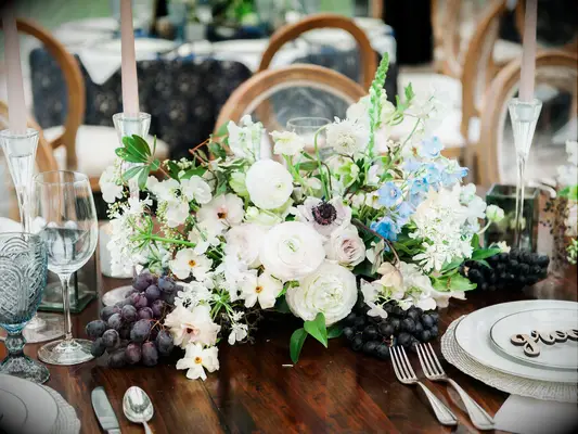 White flowers red grapes wedding table centerpieces