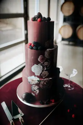 Red wedding cake with berries and florals