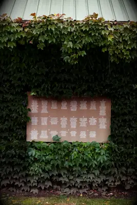 DIY kraft paper seating chart hung on ivy wall