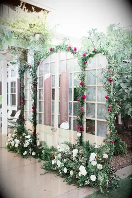 Seating chart surrounded by greenery arches