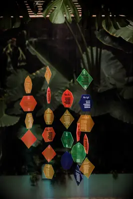 Colorful acrylic shapes hanging as part of a seating chart