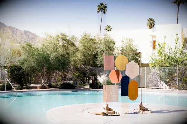 Colorful geometric seating chart at poolside Palm Springs wedding