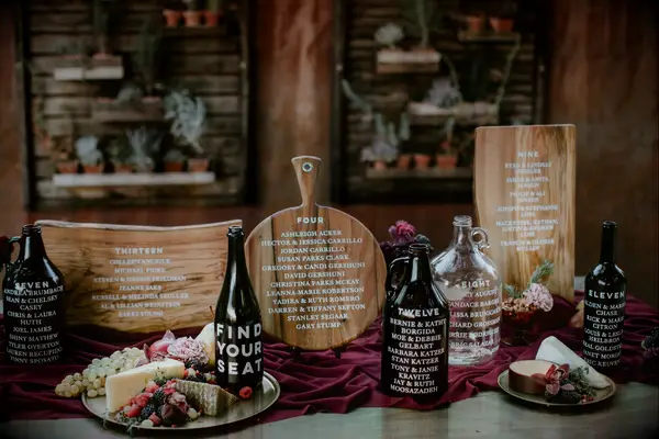 Hand-lettered wood cutting boards for seating chart display
