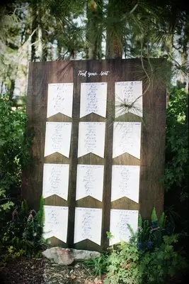 Rustic wood seating chart with pennant-inspired stationery