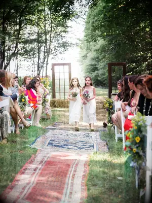 Colorful bohemian rugs at DIY wedding. 
