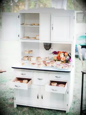 White cabinet used as pie display at DIY backyard wedding. 