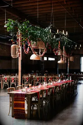 boho hanging wedding flowers with greenery vines, flower garland and mismatched rattan lampshades