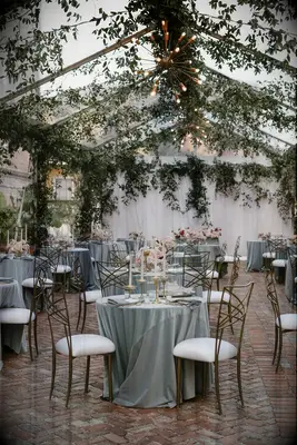 Small Round Tables With Blue Linens at Outdoor Reception, Hanging Greenery