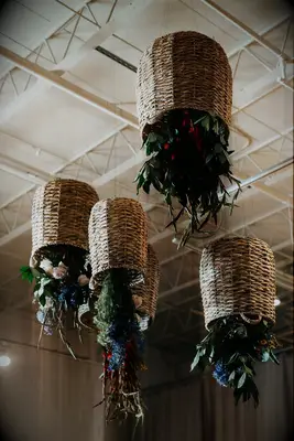 unique hanging wedding centerpiece with flowers in upside-down hanging baskets
