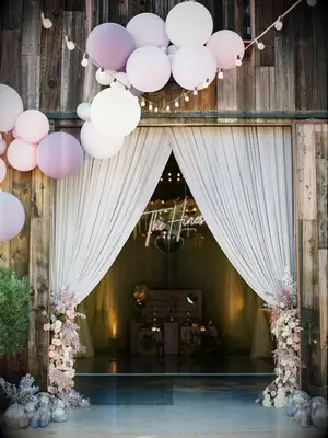 Barn door decorated with purple balloons and purple draping