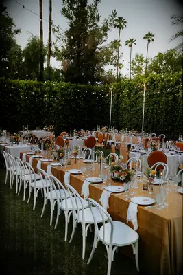 Outdoor wedding reception with burnt orange linens