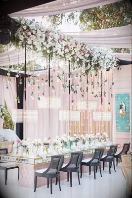 Crystal chandeliers and hanging roses at wedding reception