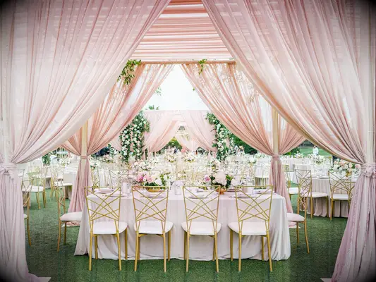 Pink drapes at outdoor wedding reception