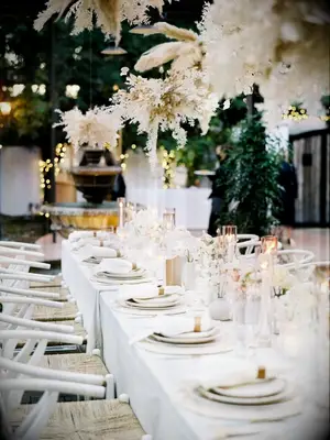 Boho all-white wedding tablescape with pampas grass