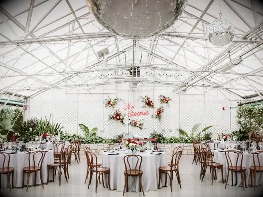 Greenhouse wedding with disco balls and neon sign