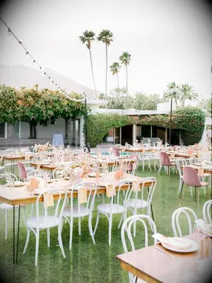 Outdoor wedding reception with bentwood chairs in palm springs