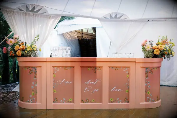 Handpainted floral wedding bar at reception