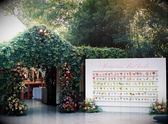 Escort card flower wall at wedding reception