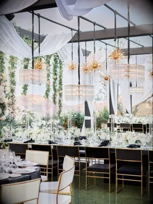 Glam wedding reception with crystal chandeliers