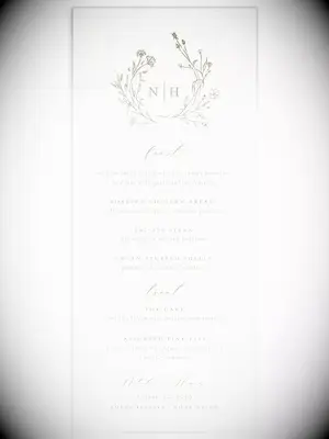 Monogram with wreath graphic and elegant brown calligraphy on white background