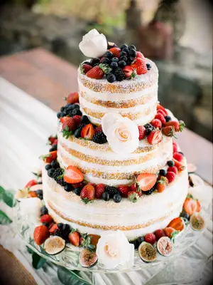 Simple naked wedding cake with fresh fruit