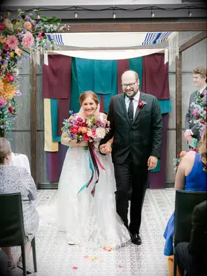 Bride and groom walking up the aisle during wedding recessional