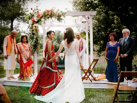 Brides walking to the altar during multi-cultural wedding ceremony
