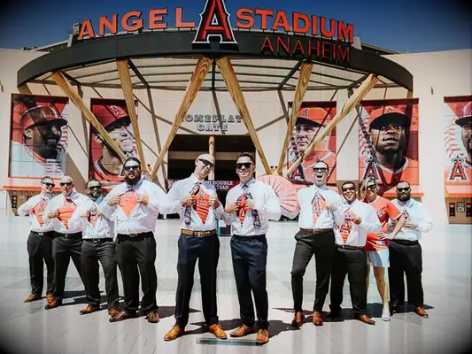 Groom and groomsmen showing off Los Angeles Angels undershirts in front of Angel Stadium