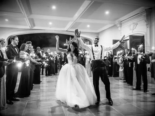 Bride and groom exiting wedding reception with sparklers