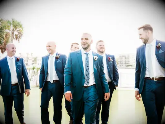 Groom and groomsmen walking to wedding ceremony