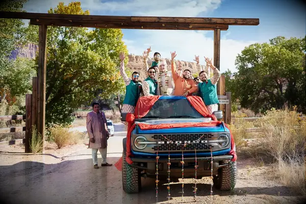 Groom and Groomsmen in Traditional Attire on Bronco Jeep in Red Rock, Zion
