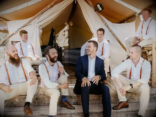 Groom chatting with groomsmen before wedding ceremony