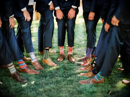 Groomsmen showing off printed socks