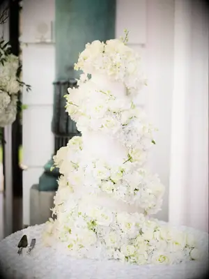 glamorous flower wedding cake wrapped with white roses spiraling down the cake