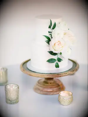 two tier white textured buttercream wedding cake with blush and ivory roses