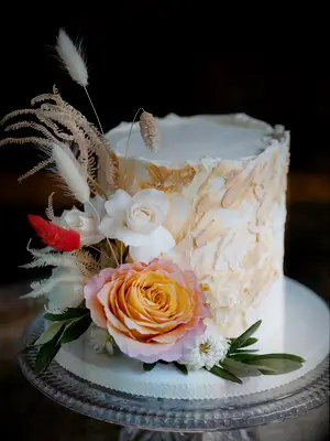 small boho wedding cake with flowers and textured buttercream