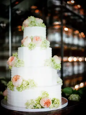 four tier textured buttercream cake with blush garden roses and green hydrangeas