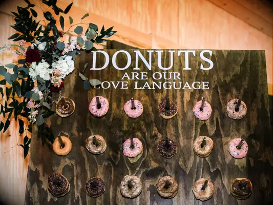 Dark wood stain donut wall with floral arrangement
