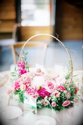 This beautiful hoop wedding centerpiece is completed by gorgeous flowers in different shades of pink.