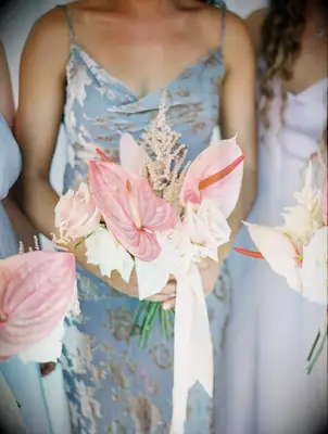 These pale pink bouquets match perfectly with dusky blue bridesmaid gowns.