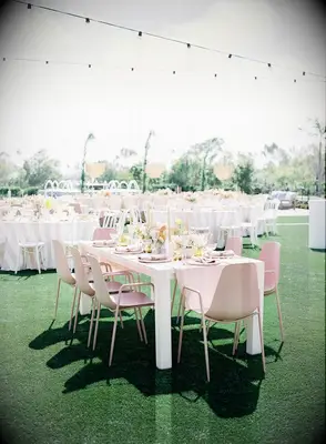 These pale pink reception chairs add a playful element to a modern weddding.