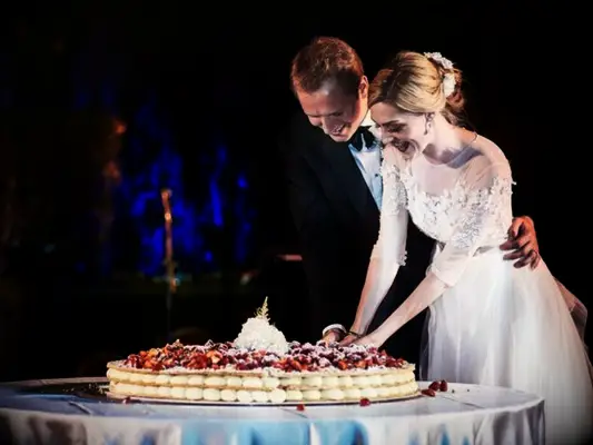 couple cutting into Italian wedding cake