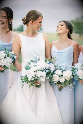 bride with her bridesmaids with white bouquets
