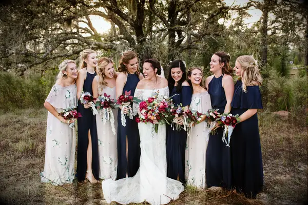 Bride and bridesmaids with beautiful red bouquets