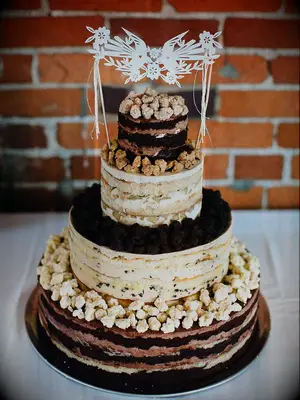 Four-tier naked rustic cake with exposed layers