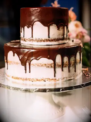 Two-tier semi-naked rustic wedding cake with chocolate ganache drizzle